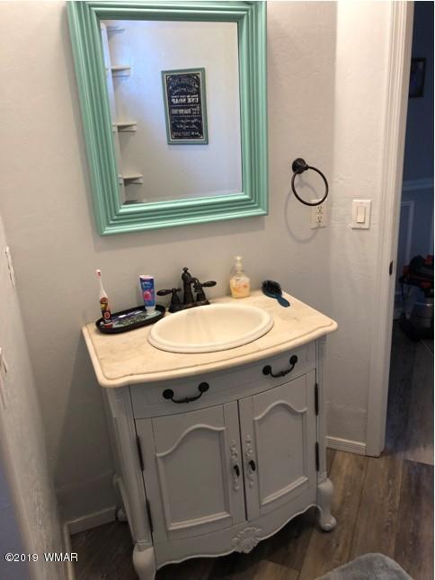 526 South 6th W Street Snowflake, AZ 85937 - Photo 34 of 36 a utility room with a sink a mirror and vanity