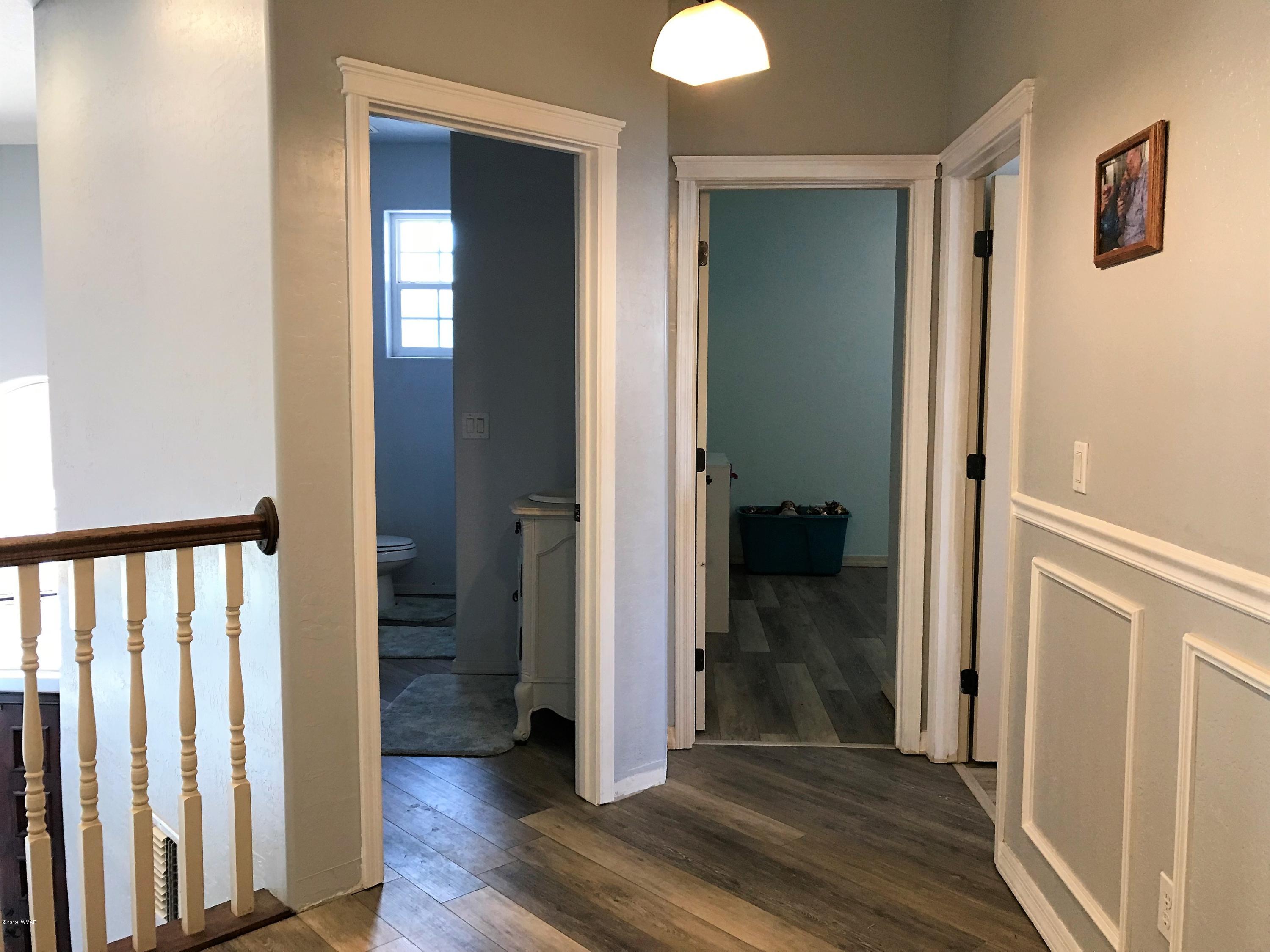 526 South 6th W Street Snowflake, AZ 85937 - Photo 36 of 36 a view of a hallway with wooden floor and closet area