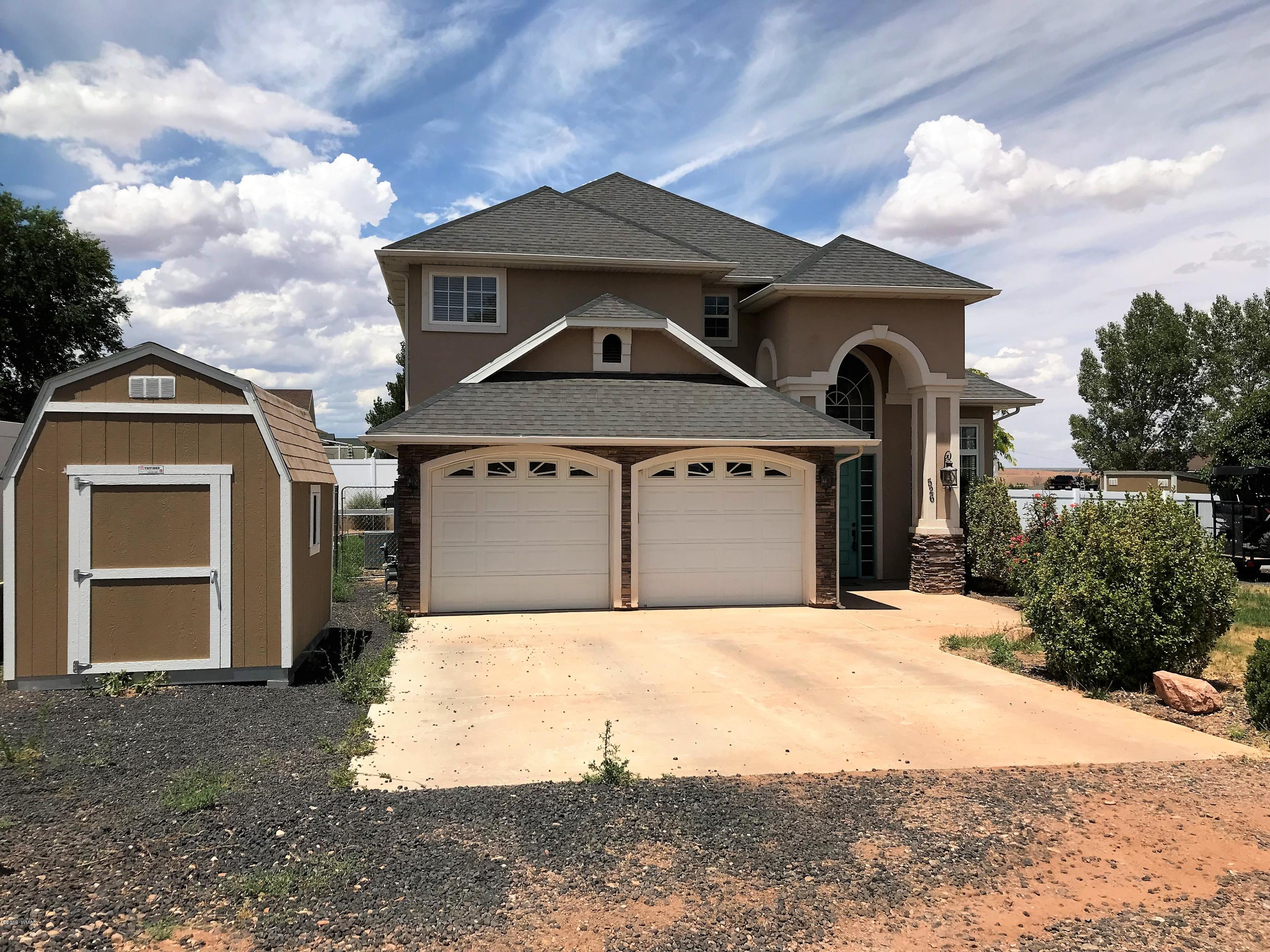 526 South 6th W Street Snowflake, AZ 85937 - Photo 5 of 36 a front view of a house with a yard and garage