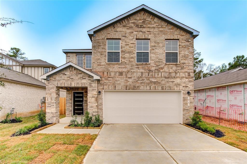 94 Valiant Ridge Trail Magnolia, TX 77354 - Photo 1 of 13 a front view of a house with garden