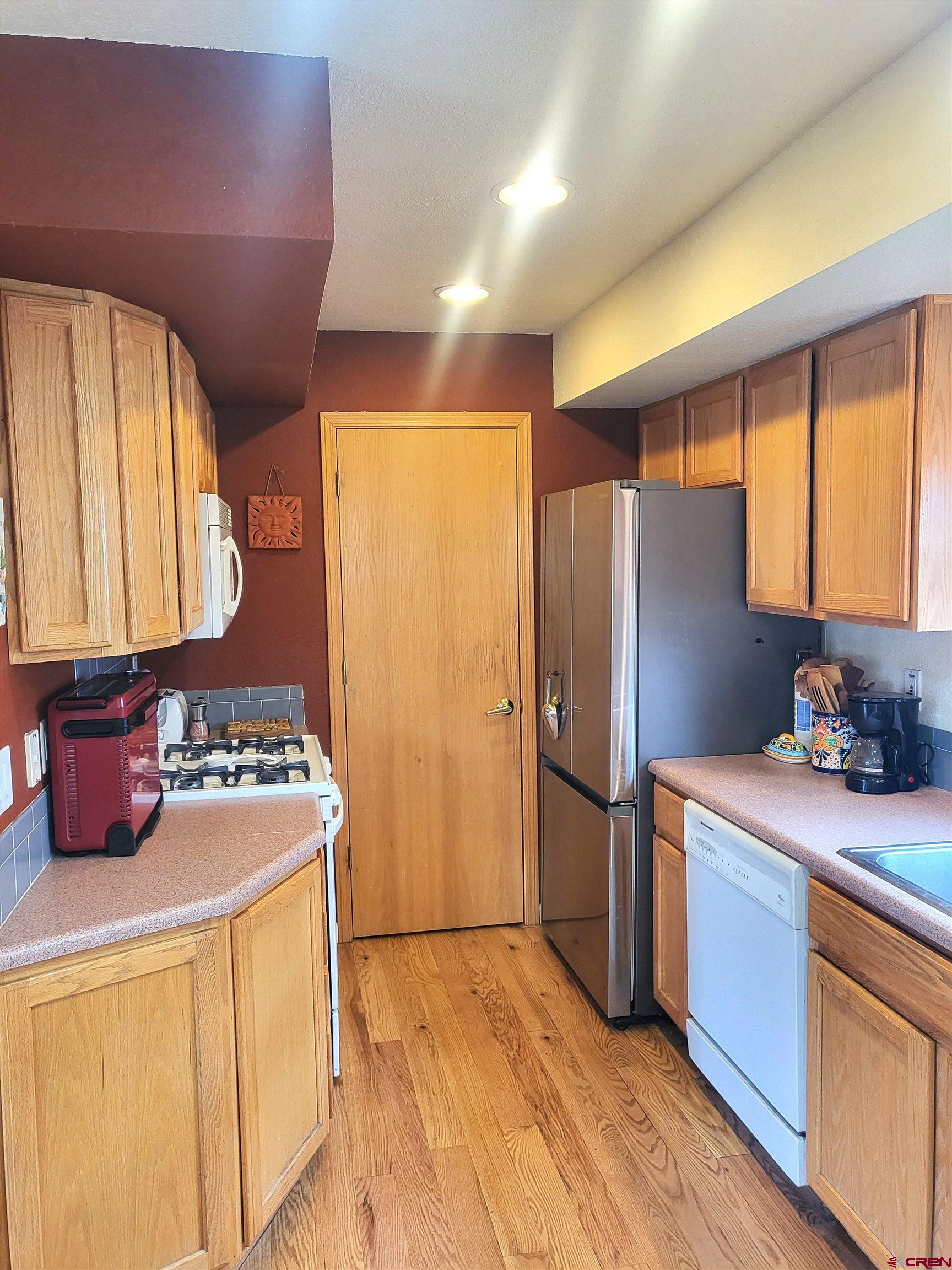 1610 Pine Street, Unit E Norwood, CO 81423 - Photo 12 of 23 a kitchen with stainless steel appliances a refrigerator sink and stove