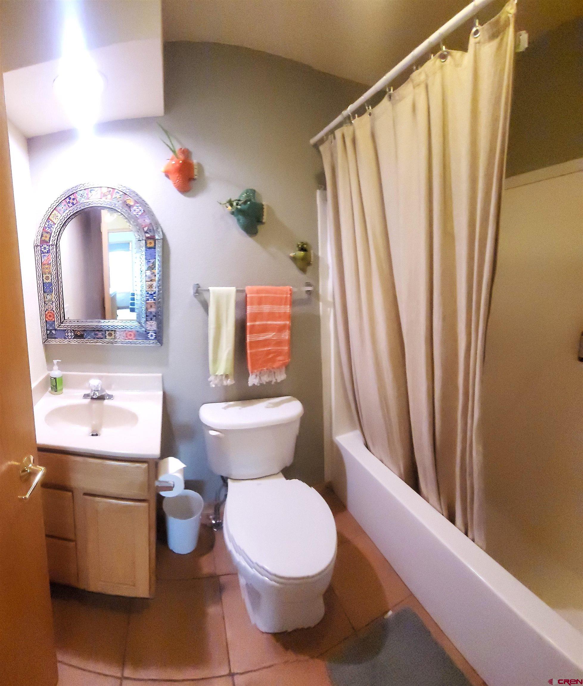 1610 Pine Street, Unit E Norwood, CO 81423 - Photo 20 of 23 a bathroom with a toilet sink and mirror