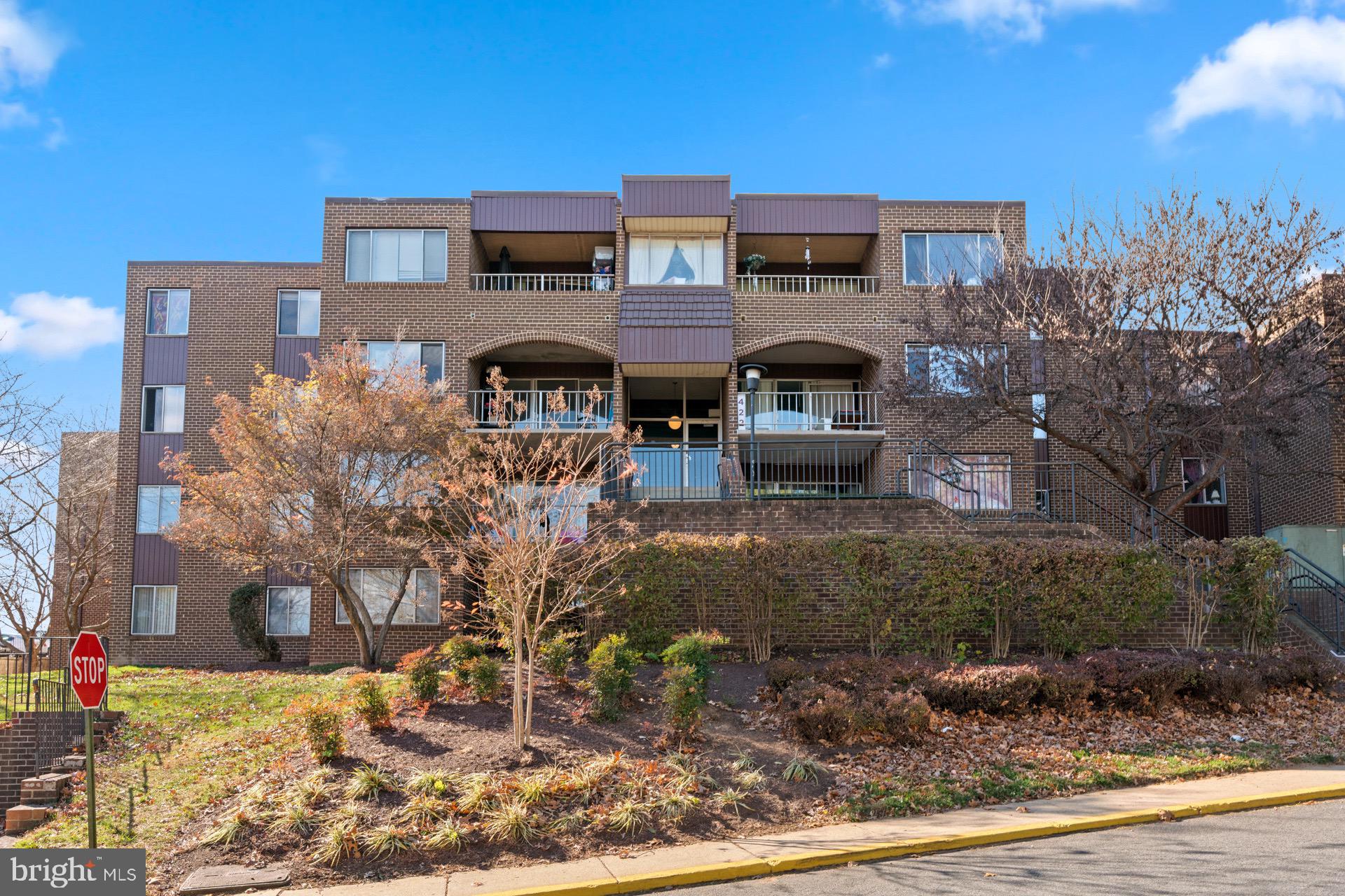 422 Girard Street, Unit 144 Gaithersburg, MD 20877 - Photo 1 of 26 a front view of a house with a yard