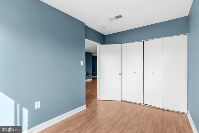 a view of an empty room and wooden floor