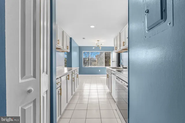 a kitchen with granite countertop a refrigerator and a sink