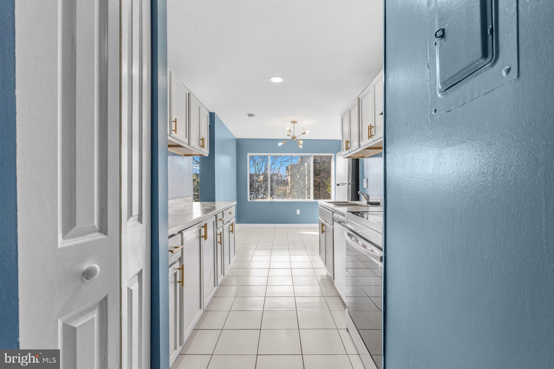 422 Girard Street, Unit 144 Gaithersburg, MD 20877 - Photo 13 of 26 a kitchen with granite countertop a refrigerator and a sink