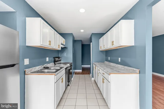 a kitchen with stainless steel appliances granite countertop a stove and a cabinets