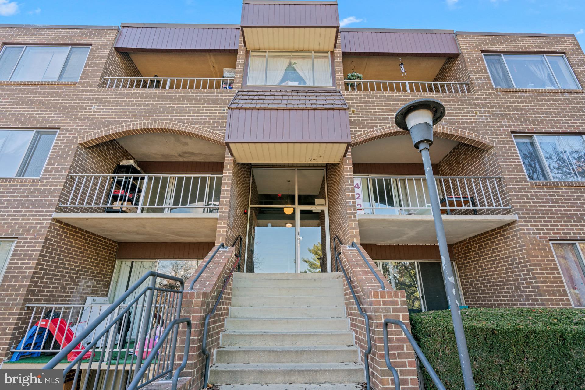 422 Girard Street, Unit 144 Gaithersburg, MD 20877 - Photo 2 of 26 a front view of a house with entryway and front door