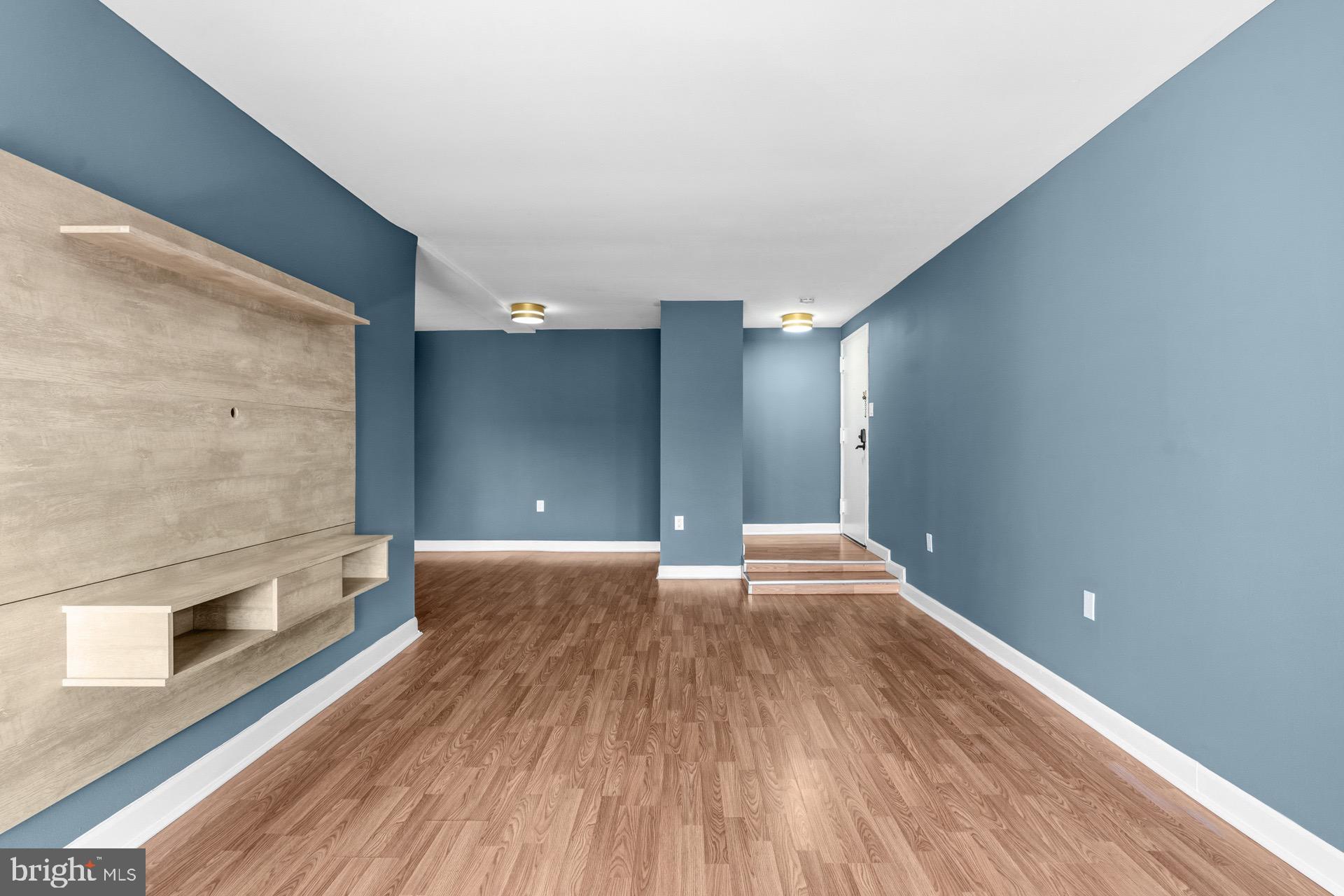 422 Girard Street, Unit 144 Gaithersburg, MD 20877 - Photo 5 of 26 a view of an empty room with wooden floor