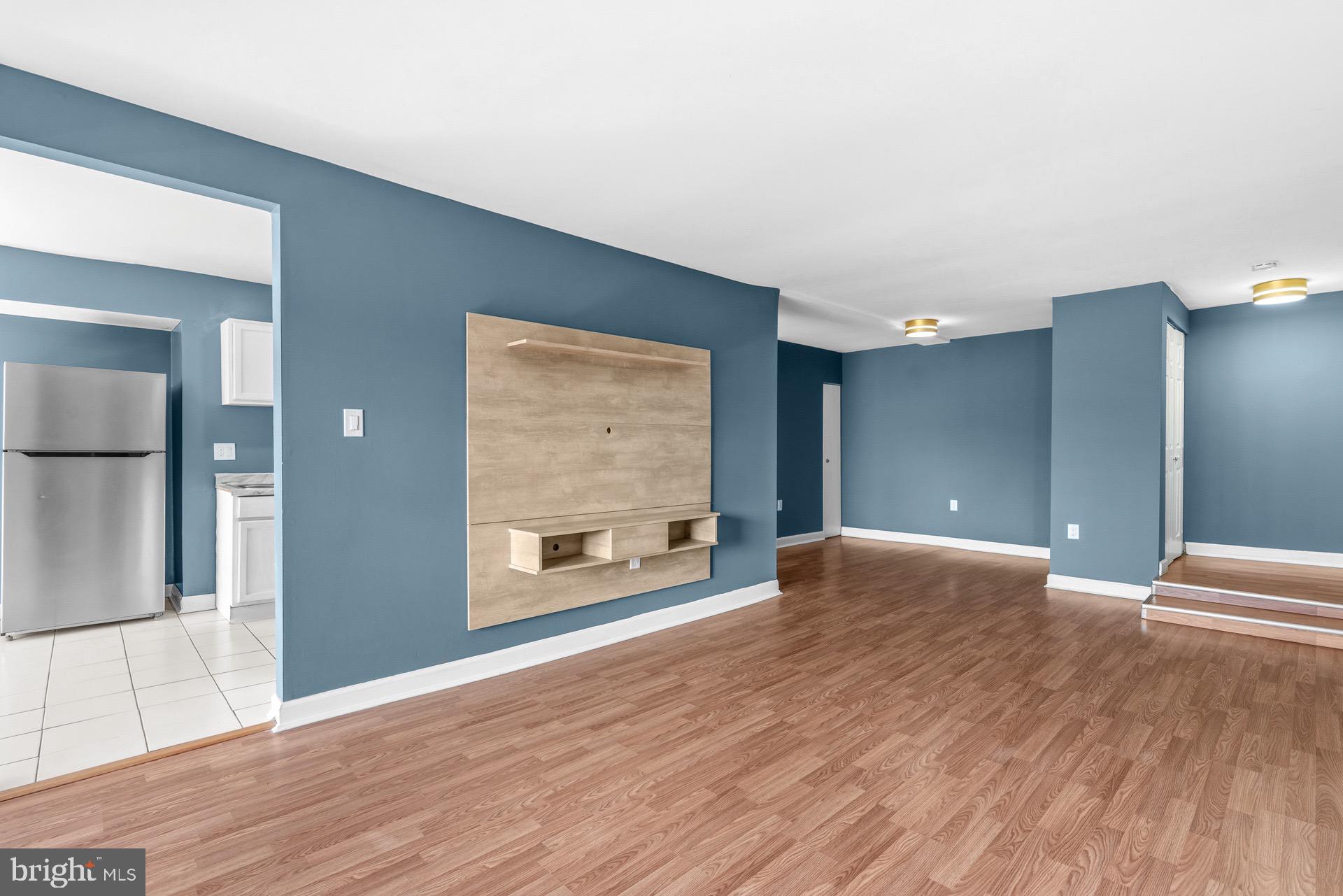 422 Girard Street, Unit 144 Gaithersburg, MD 20877 - Photo 6 of 26 a view of an empty room with wooden floor and a window