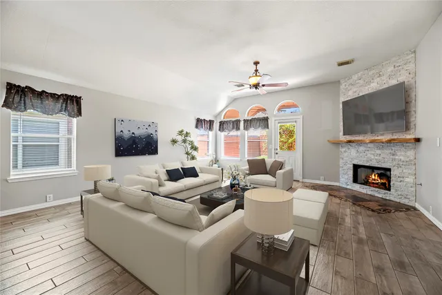 a living room with fireplace furniture and a flat screen tv