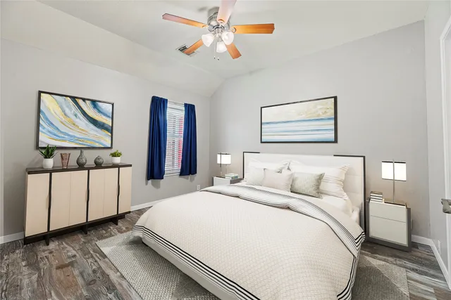 a bedroom with a large bed and a chandelier