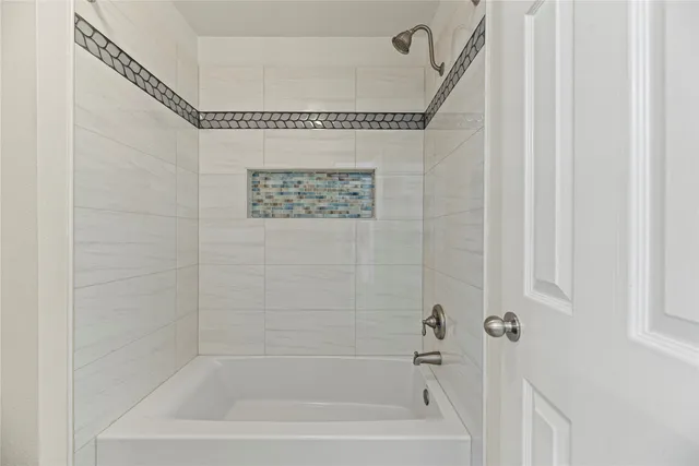 a bath room with a bath tub and a shower