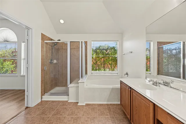 a bathroom with a tub sink and mirror