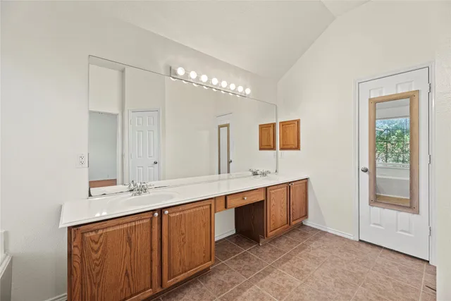 a bathroom with a double vanity sink and mirror