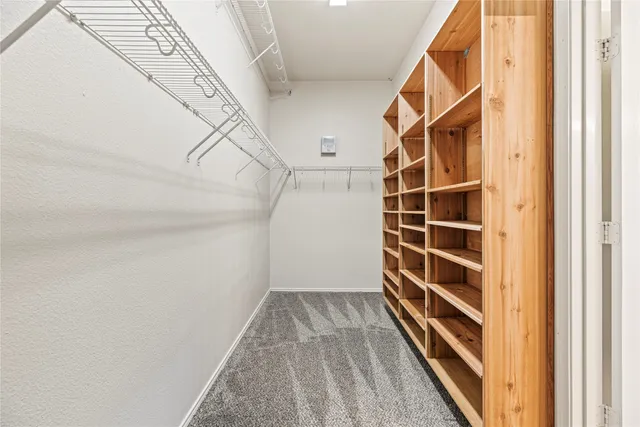 a view of walk in closet with empty racks