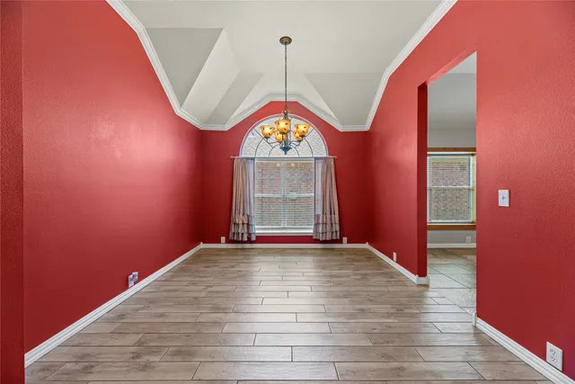 a view of an empty room window and wooden floor