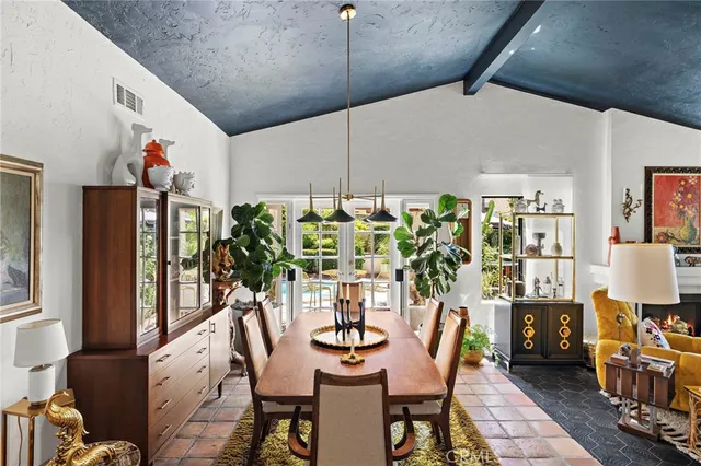 a view of a dining room with furniture and chandelier