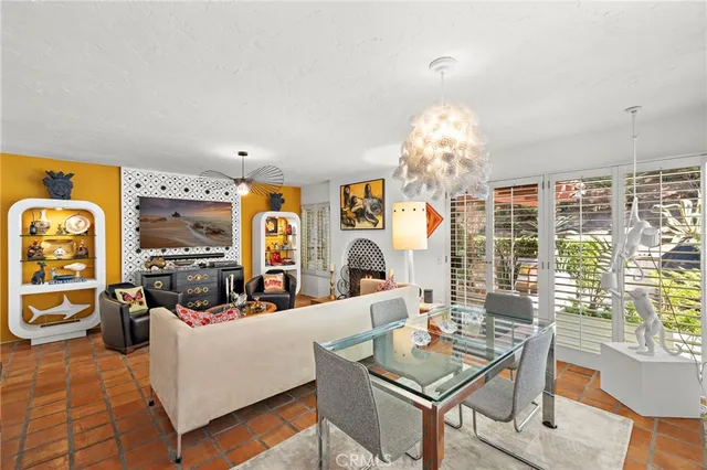 a living room with furniture a chandelier and a large mirror