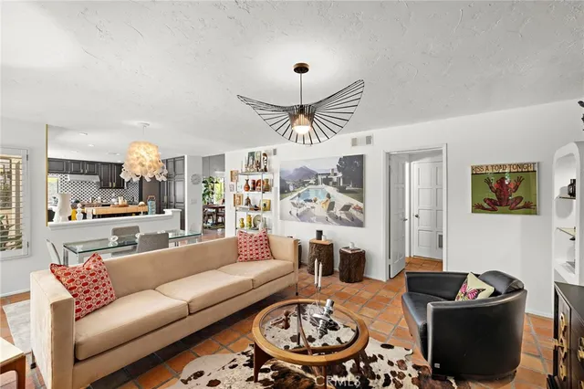 a living room with furniture and a chandelier