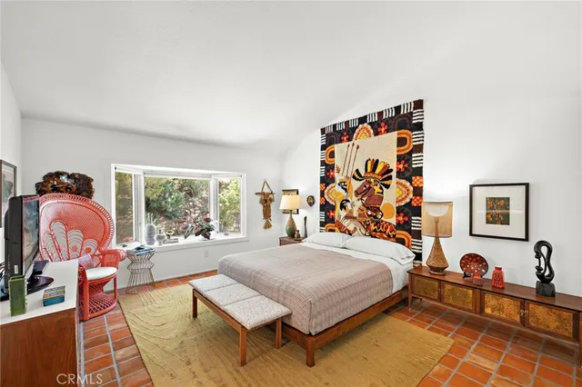 a bedroom with a bed and window