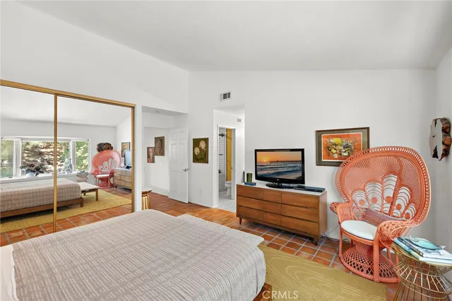 a bedroom with furniture and a flat screen tv