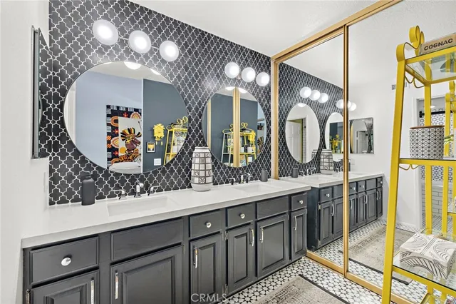 a bathroom with a double vanity sink and a mirror