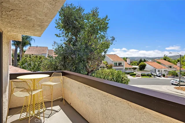 a view of a two chairs in the balcony