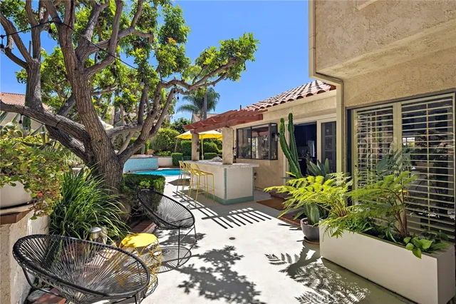 a view of a chair and tables in the patio