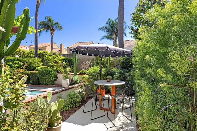 a view of a table and chairs under an umbrella in patio