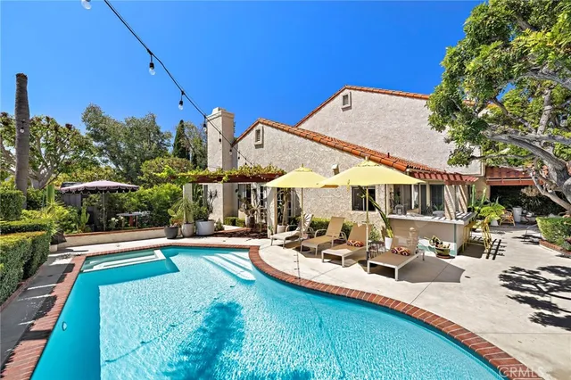 a view of a house with backyard and sitting area