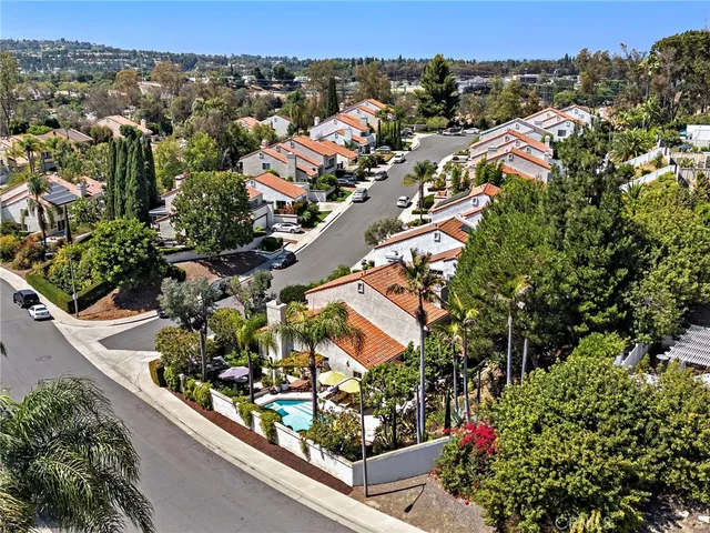 an aerial view of residential houses and car parked