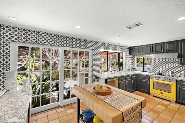 a kitchen with a stove a refrigerator and a dining table