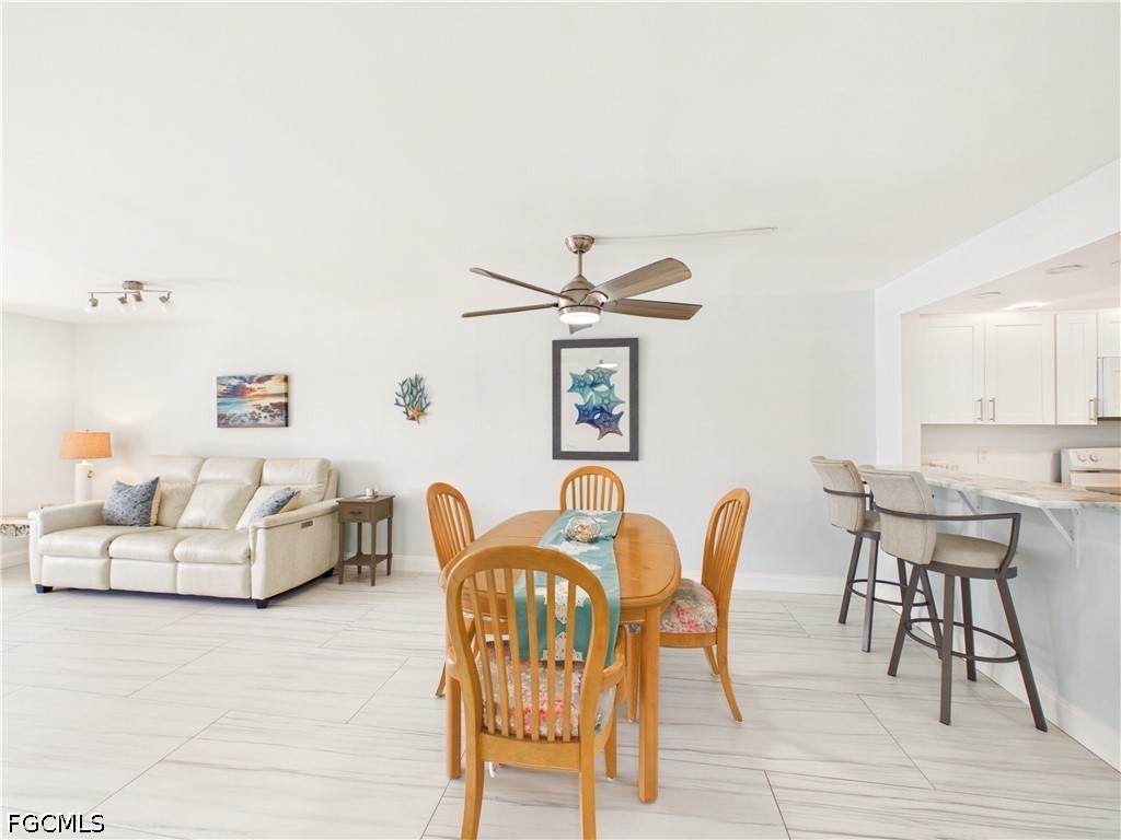 300 Valley Stream Drive, Unit 3D Naples, FL 34113 - Photo 5 of 21 a dining room with furniture and wooden floor