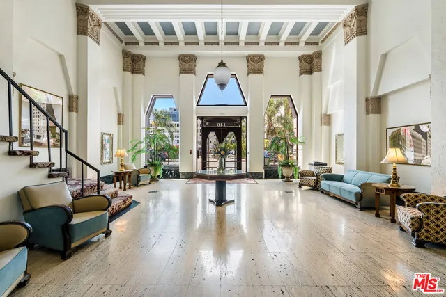 a living room with furniture fireplace and a large window