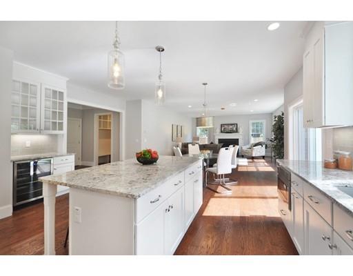 161 Peter Spring Road Concord, MA 01742 - Photo 10 of 17 a open kitchen with kitchen island a stove a sink a refrigerator dining table and chairs