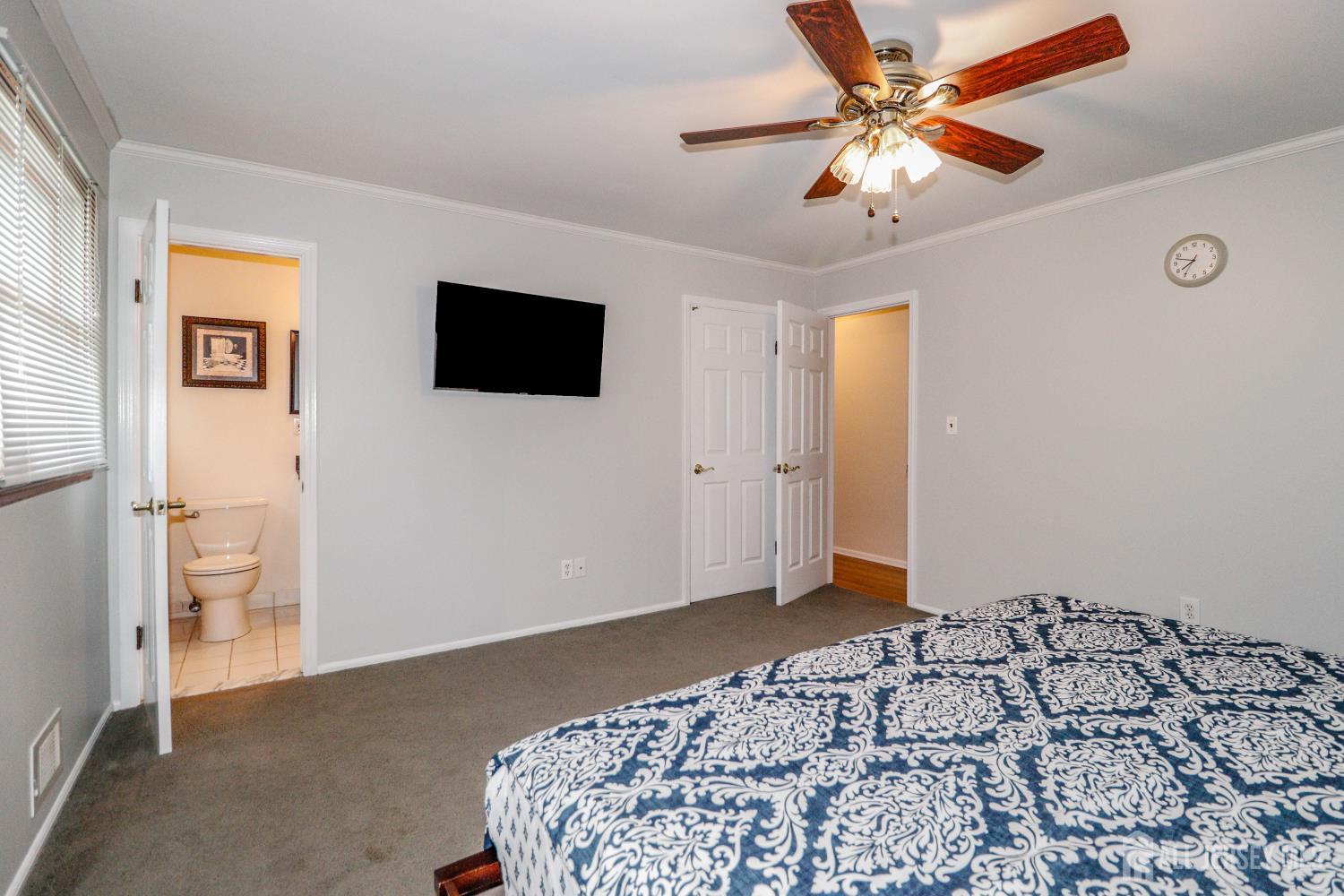 5 Timothy Court Edison, NJ 08837 - Photo 16 of 32 a bedroom with a bed and a flat screen tv