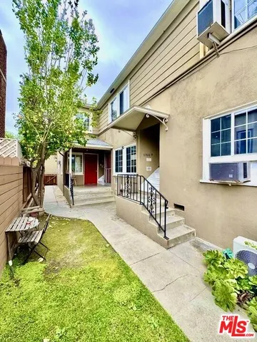 a view of a house with swimming pool and sitting area