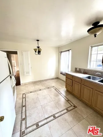 a view of a kitchen with a sink and windows