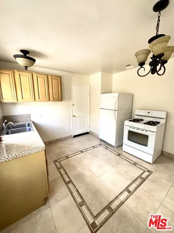 a kitchen with a stove a sink and a refrigerator