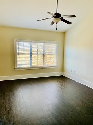 an empty room with wooden floor and a window