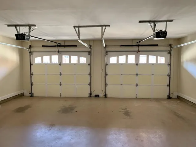 a front view of a house with a parking space