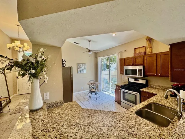 a living room with furniture a potted plant and a fireplace