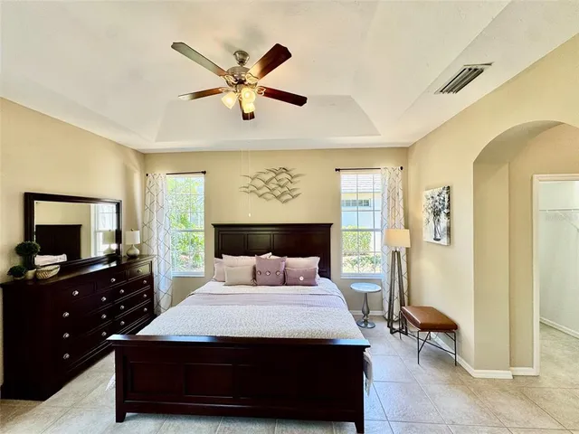 a bedroom with a bed and a chandelier