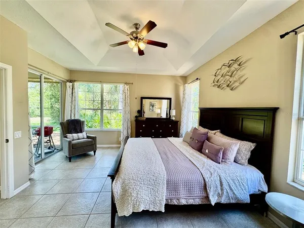 a bedroom with a bed and a large window