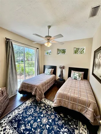 a bedroom with two beds and a large window