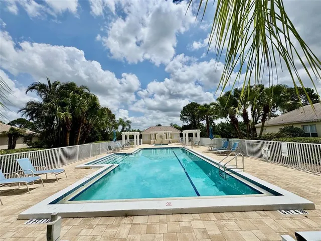 a view of a swimming pool with a yard