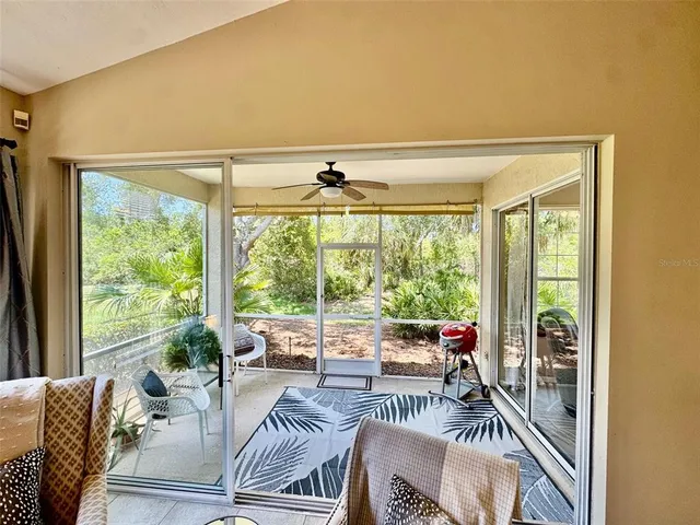 a living room with furniture and floor to ceiling windows