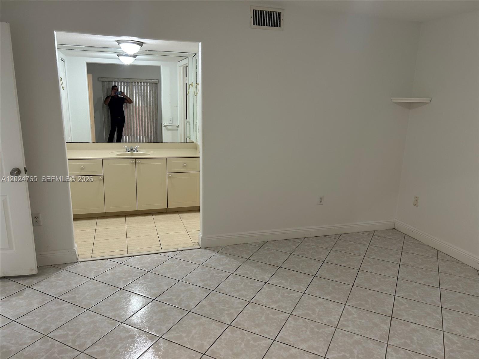 10919 West Okeechobee Road, Unit 101 Hialeah Gardens, FL 33018 - Photo 8 of 21 a view of a utility room with cabinet