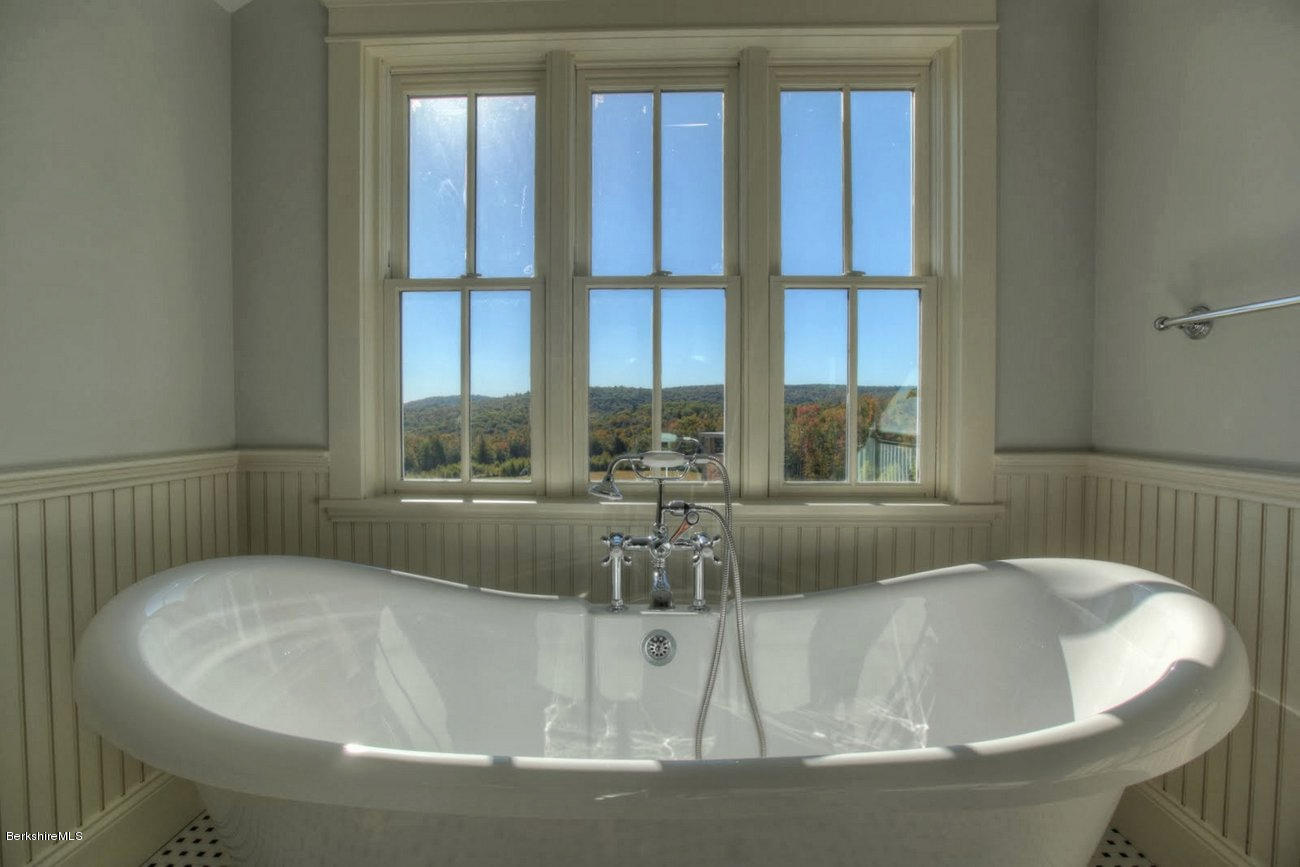 40 Viets Road Sandisfield, MA 01255 - Photo 44 of 92 a white bath tub sitting in a bathroom next to a window